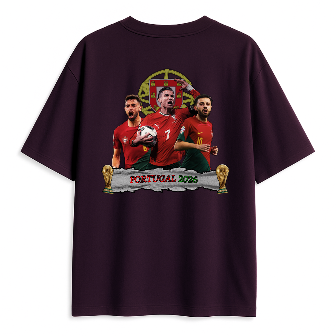 A Purple T-shirt featuring an illustrated design of three Portuguese football players in red jerseys, a football, two trophy icons, and the text ‘Portugal 2026’ on the back.